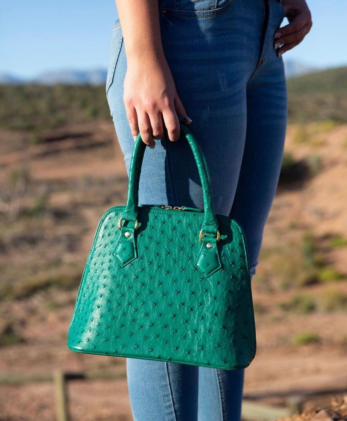 Lady carrying an Ostrich bag